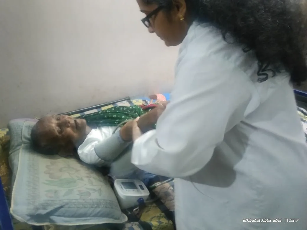 A caregiver checking on a resident resting in bed