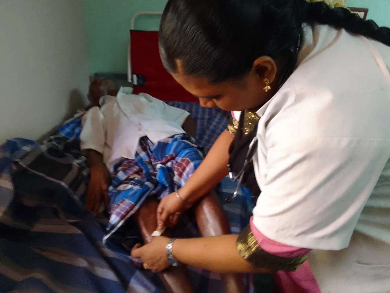 A caregiver sitting beside a resident