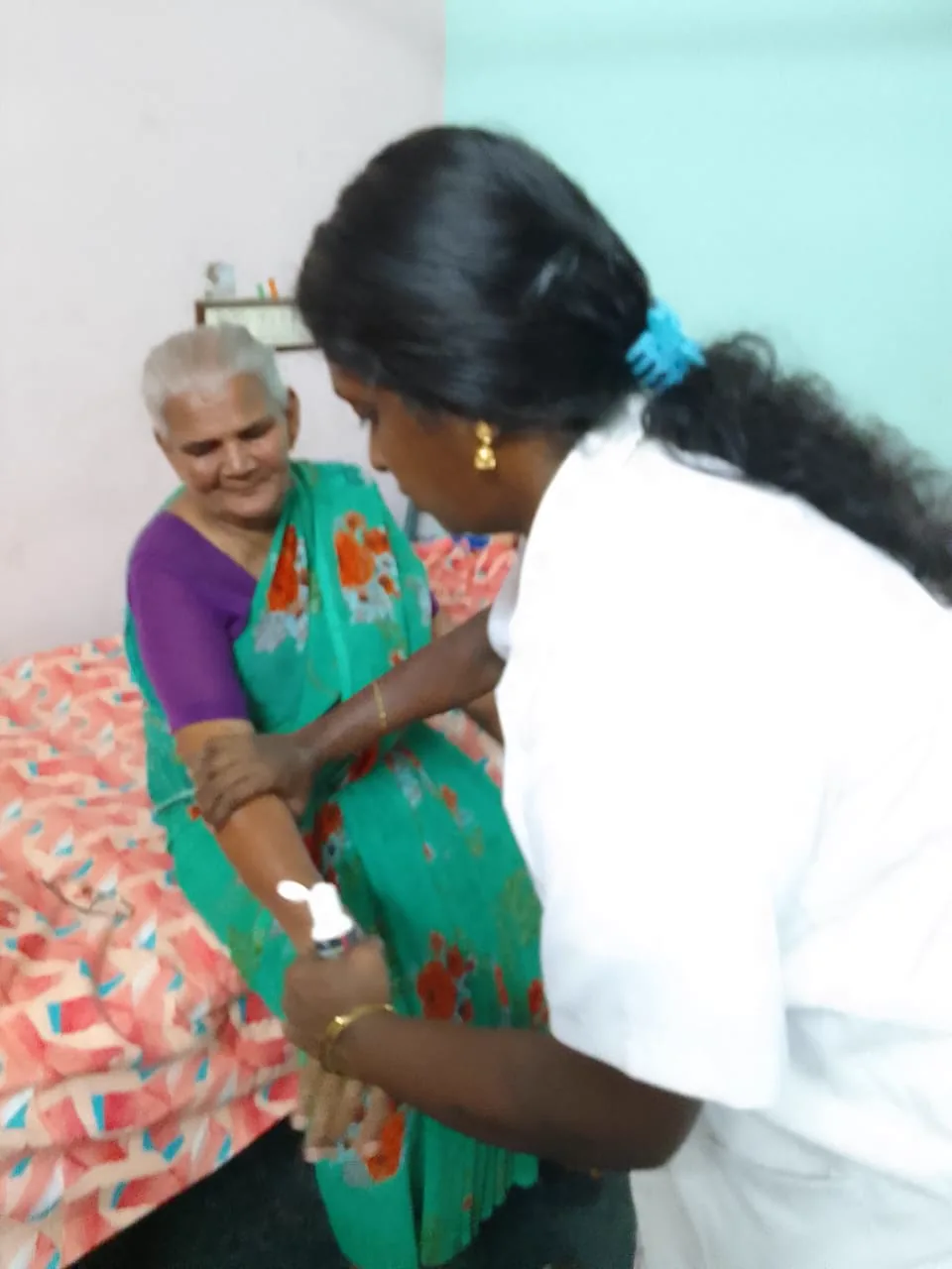 A caregiver comforting a resident at the AIPMS home